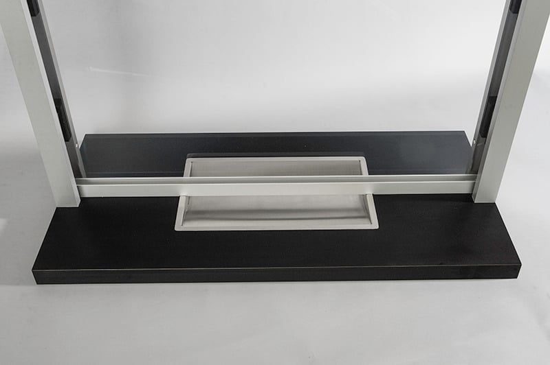 A photo displaying a bulletproof deal tray where small items like a note or cash can be securely passed through