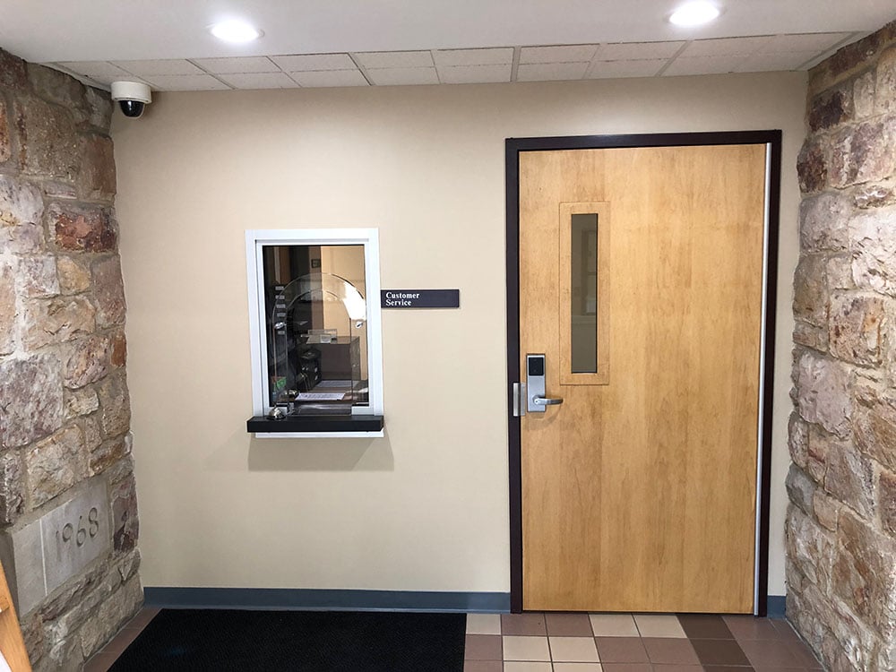 An example of a wood security door installed by TSS to deter threats and give staff more time to respond to them