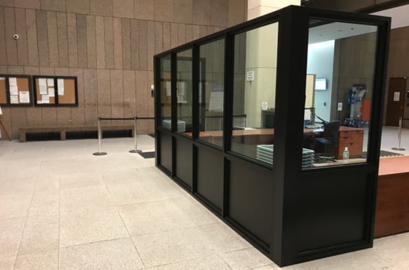 A reception area with bullet-resistant glass, a common element of government building security.