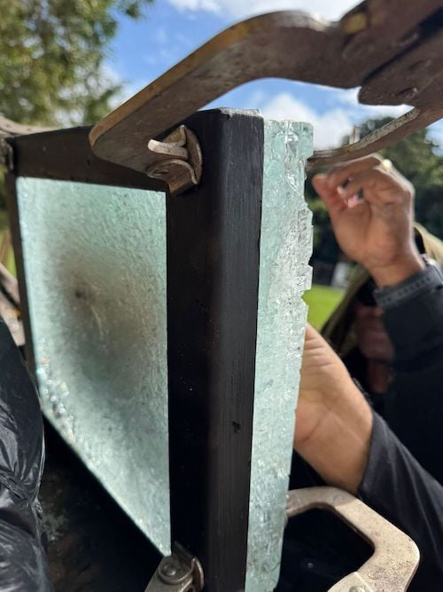 A photo shows the impact of multiple shots on Level 8 bullet-resistant panels, showcasing the level of protection the glass offers as part of architectural facility designs