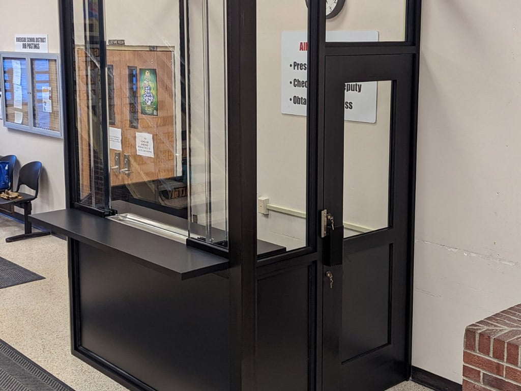 A bulletproof guard booth outfitted with a transaction window to enable safe transactions 