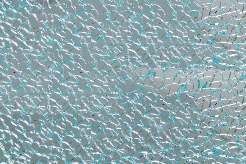 A photo depicts what can happen to laminated windows or door glass panes when they're struck by a projectile