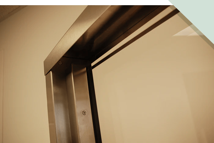 A closeup photo of stainless steel framing as part of a system for ballistic protection