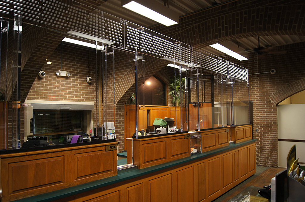  A photo showing a teller line outfitted with bullet proof glass as a protective shield from attempted attacks